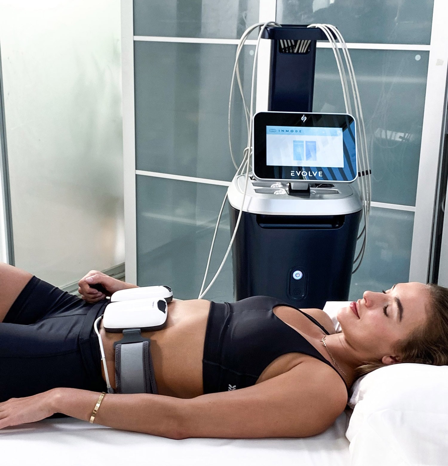 A woman has treatment with the Evolve Tone using EMS or Electro Muscular Stimulation to improve muscle tone in her abs